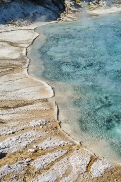 Mineral deposits at the edge of the steaming hot spring, Grand Prismatic Spring, Midway Geyser Basin, Yellowstone National Park, Wyoming, USA, North America