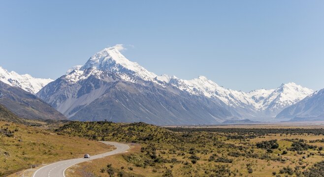 Curvy road with view to Mount Cook, snow covered mountains, Mount Cook National Park Southern Alps, Canterbury, South Island, New Zealand