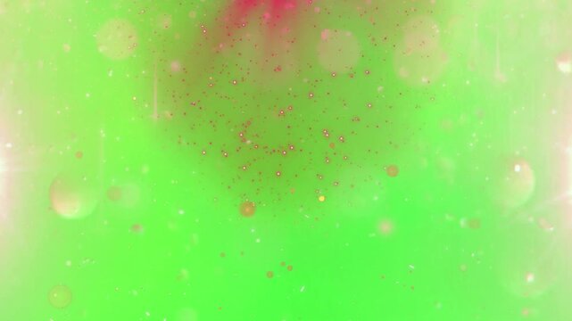 A vibrant green video background with sparkling lights and a red glow