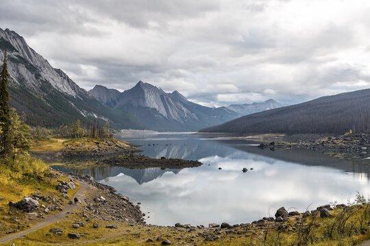 Mountains reflected in a lake, Medicine Lake, Maligne Valley, Jasper National Park, Alberta, Canada