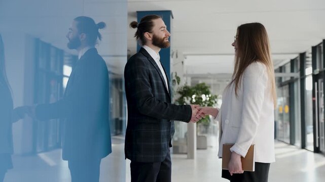 Business partners finalizing a deal with a handshake, exemplifying a strong partnership, successful collaboration, and mutual trust in a contemporary office setting