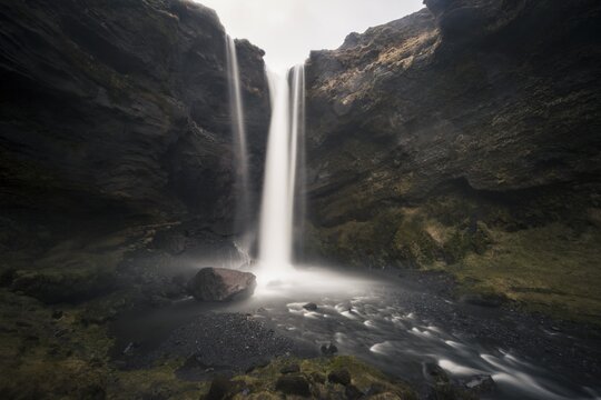 Waterfall Kvernufoss in a gorge, dramatic dark atmosphere, time exposure, near Sk&oacute;gafoss, Southurland, Iceland