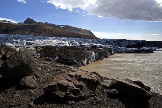 Glacial ice, glacier snout with traces of volcanic ash and glacial lake, glacier Svinafellsj&ouml;kull in Skaftafell, Southern Region, Iceland