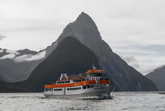 Tourist boat moving through Milford Sound, Miter Peak back, Southland, South Island, New Zealand