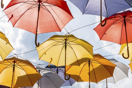 Many colorful umbrellas, sunshades, hanging in the air, sunshine, Imst, Tyrol, Austria