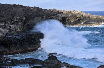 Fototapeta premium Large Wave Exploding on Maui Volcanic Lava Coast