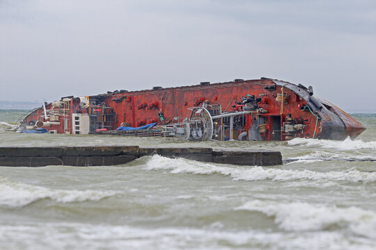 A landscape shot of a shipwrecked tanker near the coast of Odesa, a reminder of a past maritime disaster.