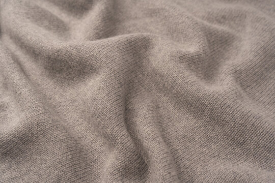 Soft grey merino wool sweater texture as a background.