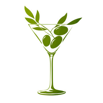 Martini glass with green olives and leaves.