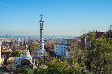 Obraz premium Park Guell,Barcelona,Spain,View of Park Guell with ornate columns and Barcelona cityscape in the background