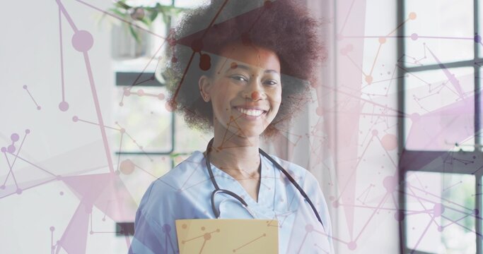 Standing nurse wearing blue scrubs holding manila folder in clinic, stethoscope and purple overlay