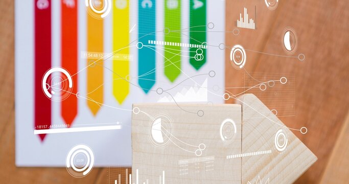 Showing two light wooden blocks forming arrow on wood table, colored chart ribbons and HUD overlays