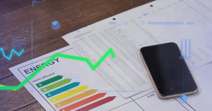 Showing printed documents featuring ENERGY chart, three-hole paper and smartphone on wooden desk