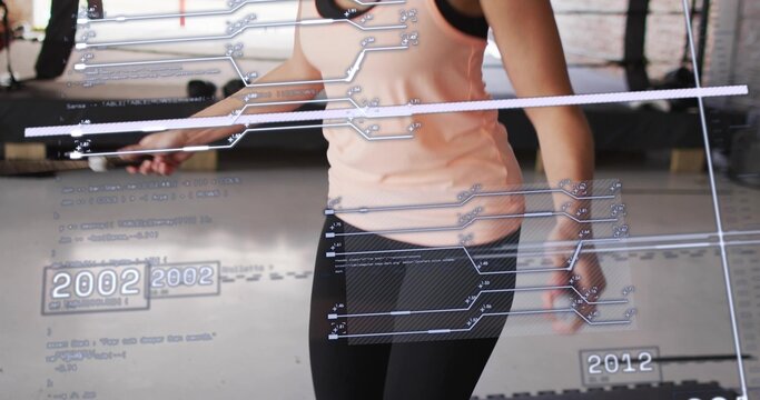 Jumping woman wearing pink tank, black leggings holding jump rope in gym, HUD displaying 2002 2012