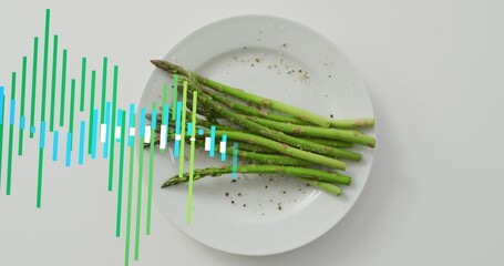 Fototapeta premium Waveform overlay appearing, showing asparagus bundle on white plate, tabletop with pepper and salt