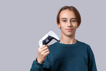 Gamer hand using video game console controller. Playing games concept. Man play a football game with video game controller. Child holding a game controller © Yevhen