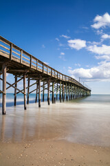 Fototapeta premium view of the Ocean Isle Beach Pier on a beautiful spring afternoon
