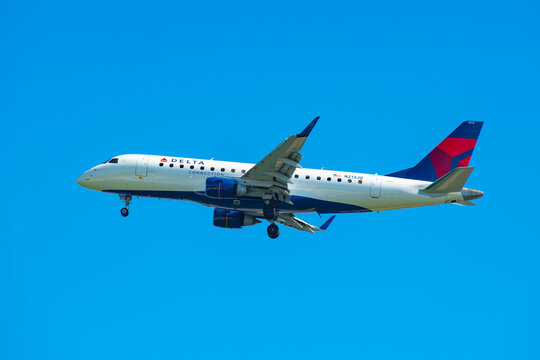 Delta Air Lines Connection Embraer ERJ-175 N213JQ landing on Boston Logan International Airport, Boston, Massachusetts MA, USA.