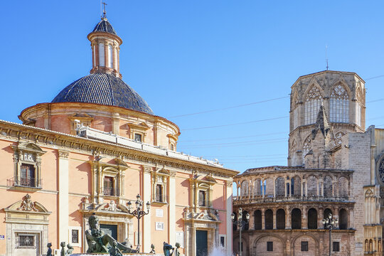 Ciutat Vella,Valencia,Spain,Historic architectural structures featuring a domed building and a Gothic cathedral under a clear blue sky