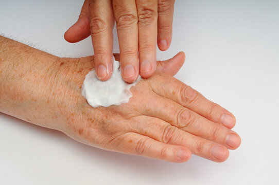 Hands Applying Skincare Cream