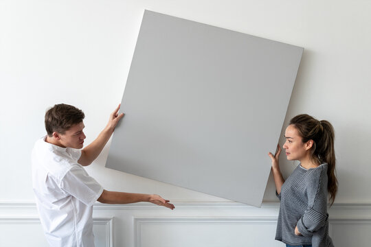 Two people discussing blank canvas, suitable as mockup