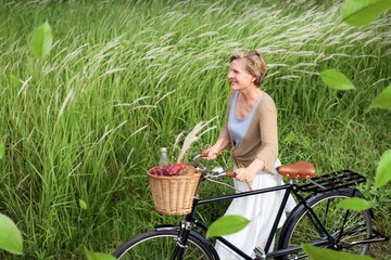 Fototapeta premium Mature woman with a bicycle