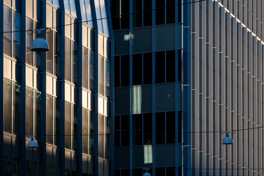 Modern urban corporate offices and buildings facade with glass windows showing architecture pattern and geometric lines for contemporary city background