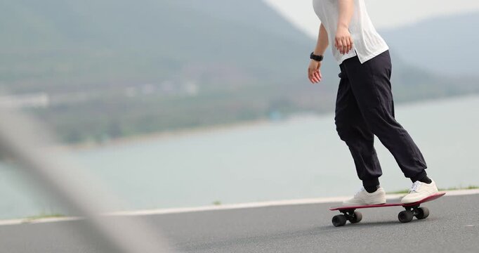 Woman skateboarding at the seaside