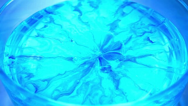 Hypnotic Flow of Vibrant Blue and Turquoise Liquids Mixing in Scientific Chemistry Demonstration Fluid Dynamics Abstract Macro Shot
