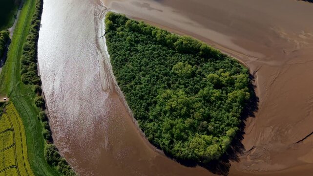 Aerial drone view of Howden Island and the River Ouse, showcasing a unique forested landform and green landscape near Goole, UK.
