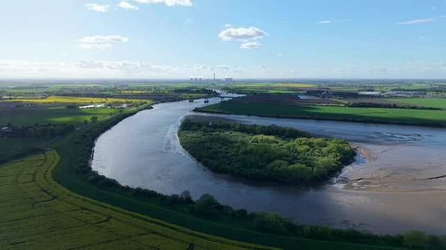 Aerial drone view of Howden Island and the River Ouse, showcasing a unique forested landform and green landscape near Goole, UK.