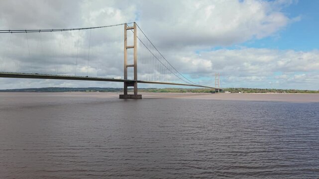 Aerial drone view of the Humber Bridge suspension crossing over the brown tidal estuary