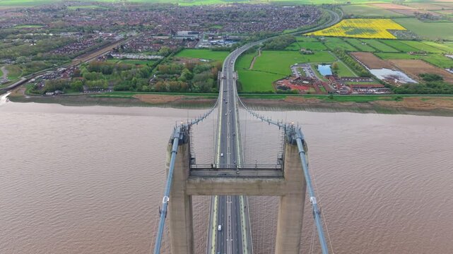High angle tracking view of vehicles driving over the historic Humber Bridge highway crossing in England
