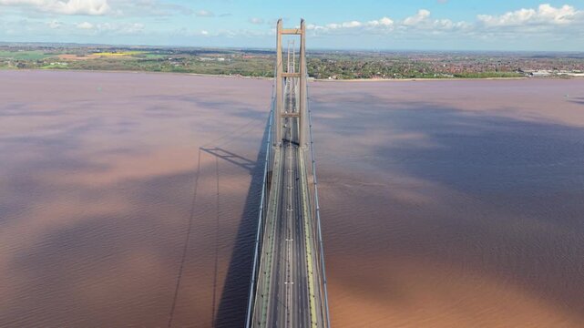 Aerial drone view of the Humber Bridge suspension crossing over the brown tidal estuary