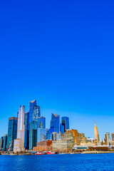 Fototapeta premium Hudson Yards shines against a clear blue sky in the Manhattan skyline
