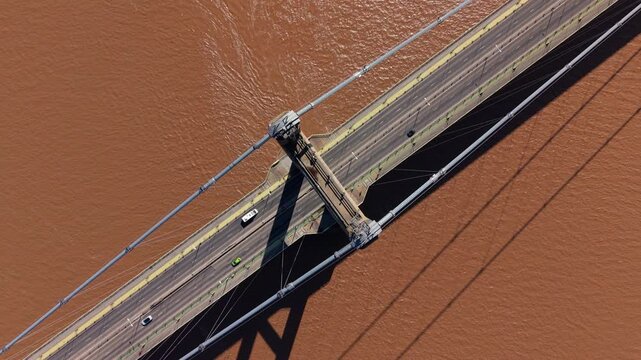 Cinematic close up of the Humber Bridge road deck and suspension system over brown river water