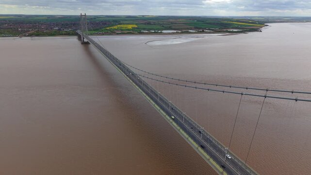 High angle tracking view of vehicles driving over the historic Humber Bridge highway crossing in England