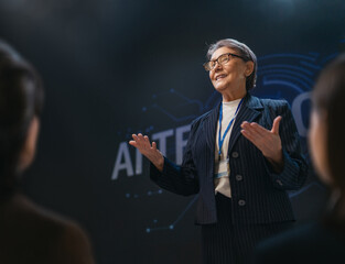 Confident Senior Businesswoman Speaking at Technology Conference