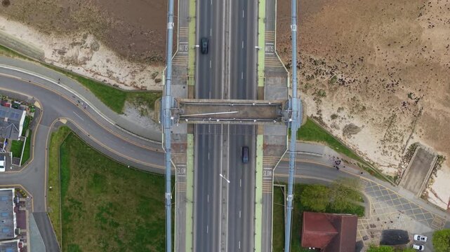 High angle view of road traffic driving across the Humber Bridge in East Yorkshire UK