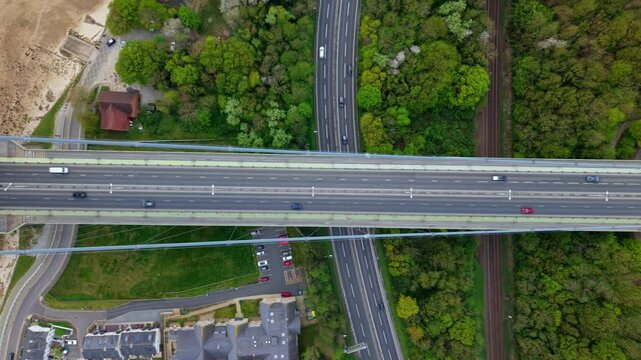 Top down aerial view of Hessle Foreshore and the Humber Bridge tower over the muddy estuary shoreline UK