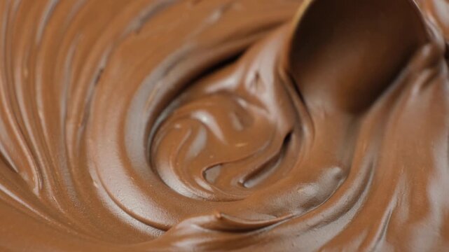 Stirring chocolate spread with a spoon, macro texture