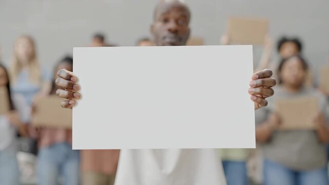 Person holding blank protest sign at rally, freedom of speech and social activism concept.