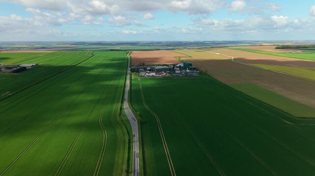 Aerial drone view of a biogas renewable energy facility with anaerobic digesters in rural Lincolnshire fields UK
