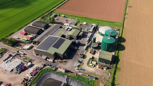 Drone shot of a rural renewable energy plant generating biogas from agricultural waste in the English countryside