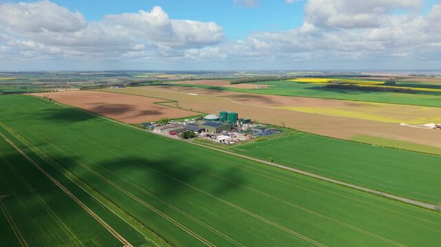 Drone shot of a rural renewable energy plant generating biogas from agricultural waste in the English countryside