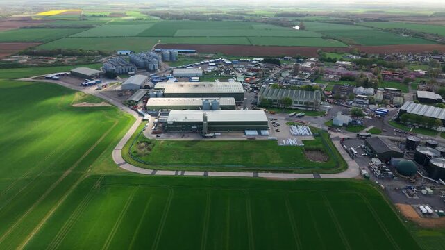 Aerial drone view of industrial units and agricultural grain storage silos in rural Lincolnshire near Hemswell Cliff UK