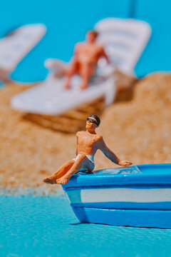 a miniature man sitting on a small boat