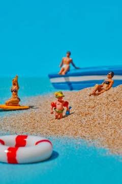 a miniature child standing on the sand of a beach