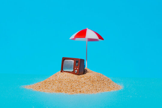 a vintage television on a tiny beach