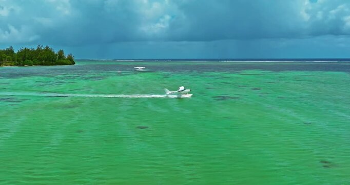Aerial view of hydroplane is taking off or landing on a crystal clean water. Mauritius